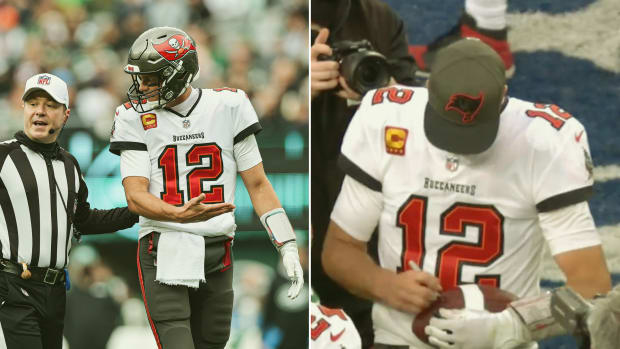Tom Brady signs an autograph for a rookie who intercepted him